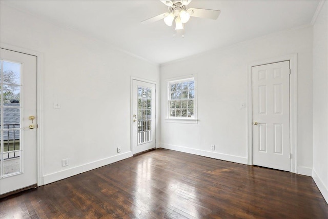 spare room featuring dark wood-type flooring, ceiling fan, and baseboards