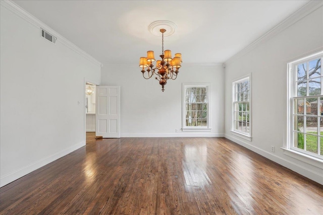 spare room with baseboards, visible vents, dark wood finished floors, crown molding, and a chandelier