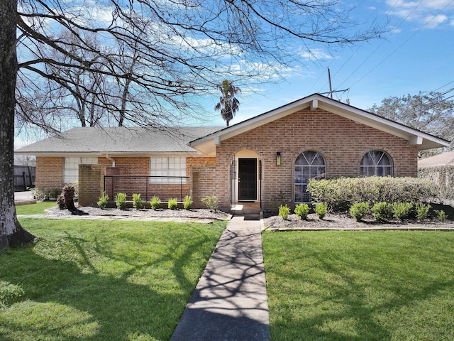 single story home featuring brick siding and a front lawn