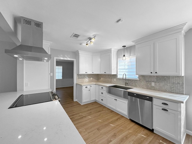 kitchen with dishwasher, ventilation hood, a sink, stovetop, and white cabinets