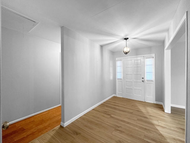 entrance foyer featuring light wood finished floors and baseboards