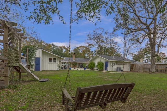 view of yard featuring central AC unit and a storage unit