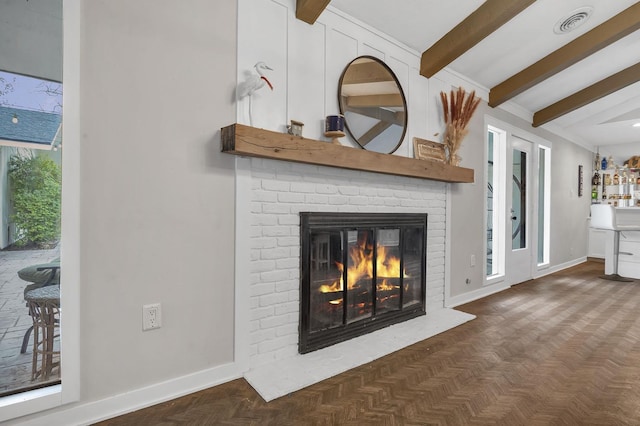 interior details with parquet floors, a fireplace, and beamed ceiling