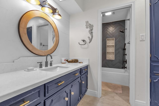 bathroom with vanity, tiled shower / bath combo, and tile patterned floors