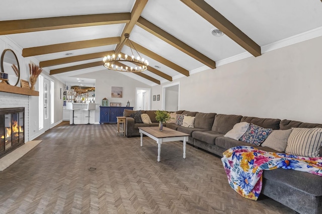 living room with a brick fireplace, lofted ceiling with beams, dark parquet floors, and a notable chandelier