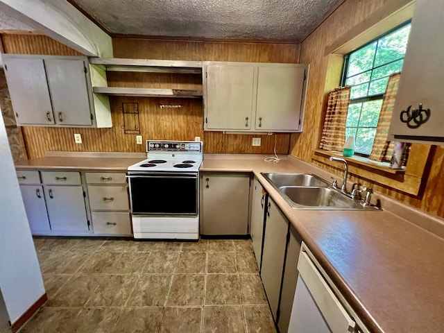 357 Hawks, Kountze, TX 77625 - kitchen featuring white electric range oven, wood walls, light countertops, and a textured ceiling
