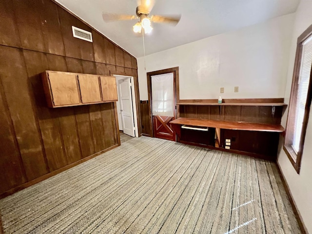 357 Hawks, Kountze, TX 77625 - interior space with lofted ceiling, a ceiling fan, wooden walls, and light carpet