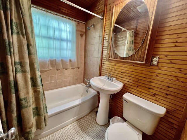 357 Hawks, Kountze, TX 77625 - full bath featuring wood walls, shower / tub combo with curtain, and tile patterned floors
