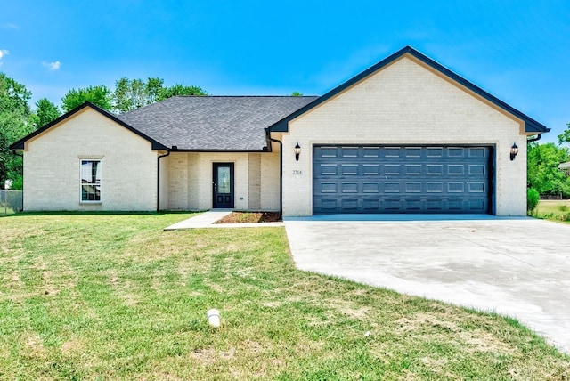 view of front of house featuring a garage and a front lawn