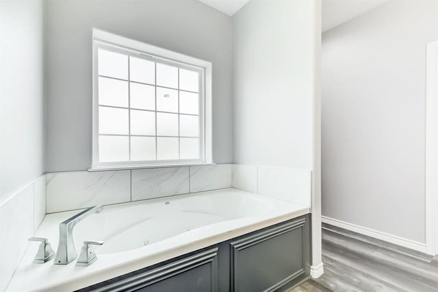 bathroom featuring a washtub and wood-type flooring