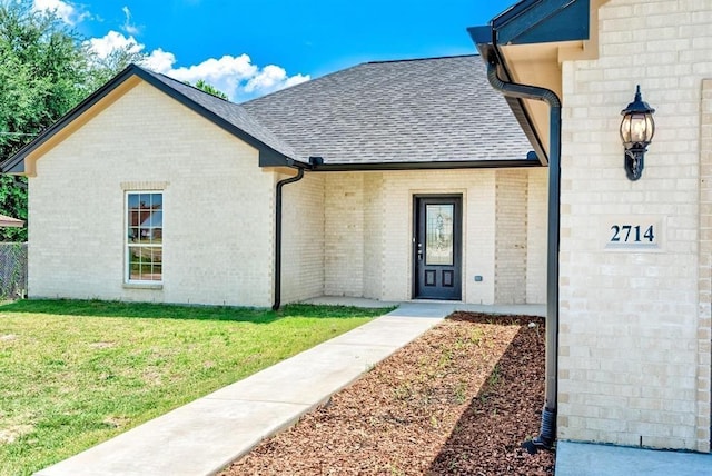 entrance to property with a yard