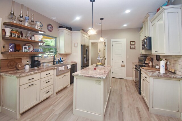 115 Pr 5250, Warren, TX 77664 - kitchen with stainless steel appliances, tasteful backsplash, a kitchen island, light wood-style flooring, and recessed lighting