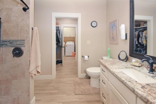 115 Pr 5250, Warren, TX 77664 - full bathroom with washer / clothes dryer, vanity, wood finished floors, a spacious closet, and a tile shower