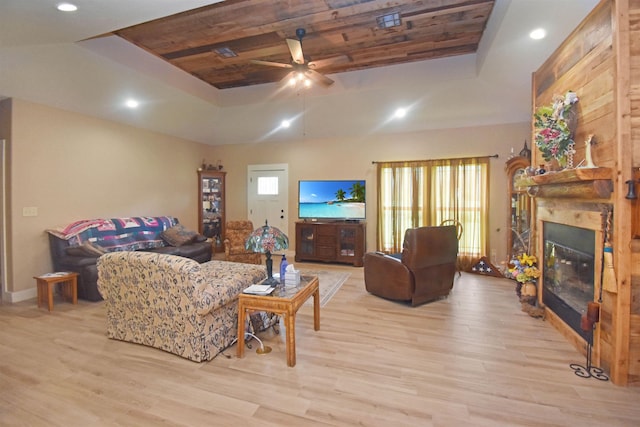 115 Pr 5250, Warren, TX 77664 - living area with a tray ceiling, light wood finished floors, a glass covered fireplace, ceiling fan, and recessed lighting