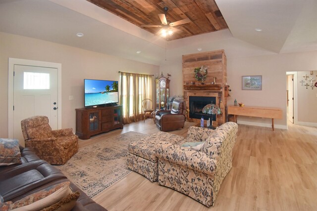 115 Pr 5250, Warren, TX 77664 - living room with light wood-type flooring, a ceiling fan, a fireplace, and a raised ceiling