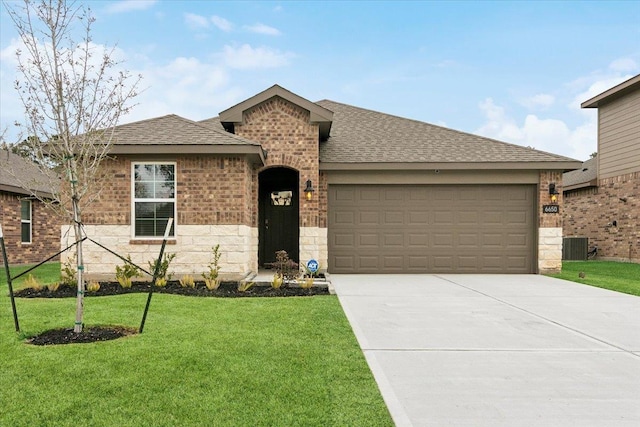 single story home with brick siding, a shingled roof, an attached garage, a front yard, and driveway