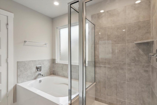 bathroom featuring separate shower and tub