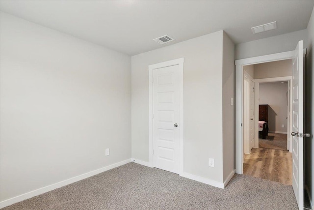 unfurnished bedroom with carpet flooring and a closet