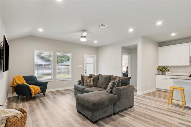 living room with vaulted ceiling, ceiling fan, and light hardwood / wood-style floors