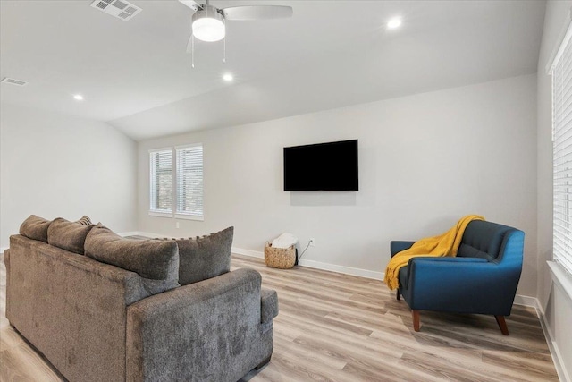 living room with ceiling fan, lofted ceiling, and light hardwood / wood-style floors