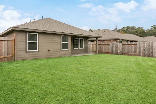 rear view of property with a patio and a yard