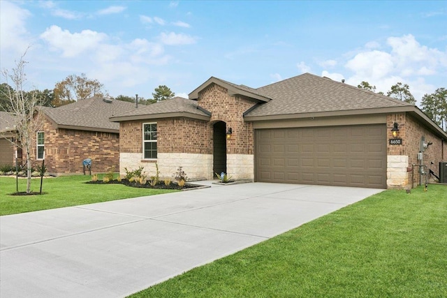 ranch-style house featuring central AC unit, a garage, and a front yard