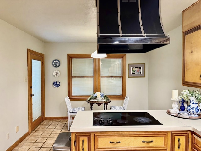 200 Hazel Dr, Village Mills, TX 77663 - kitchen featuring black electric cooktop, light countertops, light tile patterned floors, a peninsula, and baseboards
