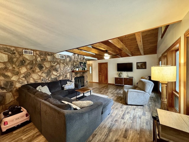 200 Hazel Dr, Village Mills, TX 77663 - living area featuring wood finished floors, ceiling fan, beam ceiling, and a fireplace