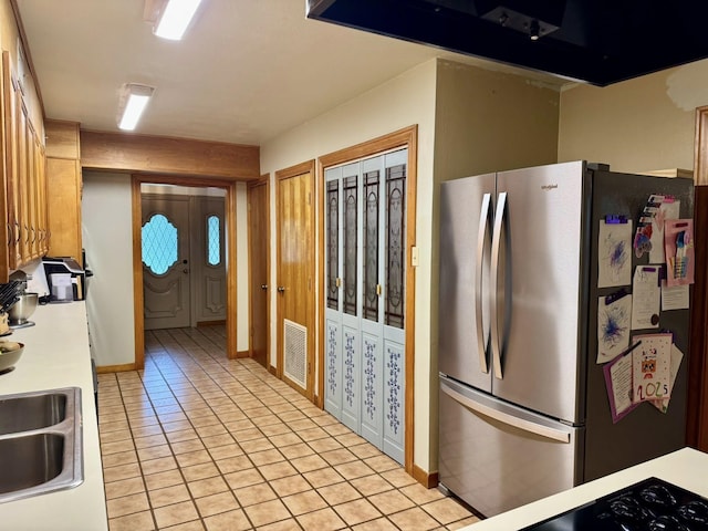 200 Hazel Dr, Village Mills, TX 77663 - kitchen featuring freestanding refrigerator, extractor fan, light tile patterned floors, light countertops, and french doors