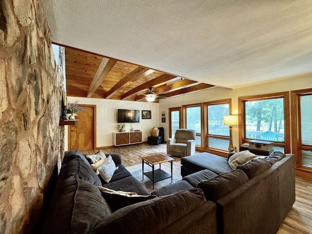 200 Hazel Dr, Village Mills, TX 77663 - living area featuring wood finished floors, ceiling fan, beamed ceiling, a textured ceiling, and baseboards