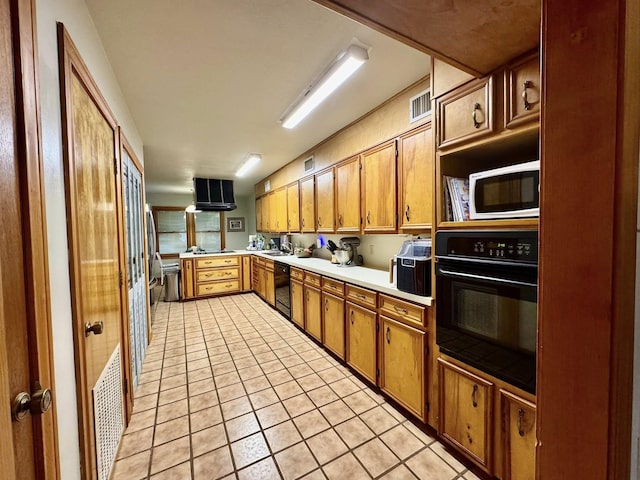 200 Hazel Dr, Village Mills, TX 77663 - kitchen with black appliances, light tile patterned flooring, brown cabinets, and a sink
