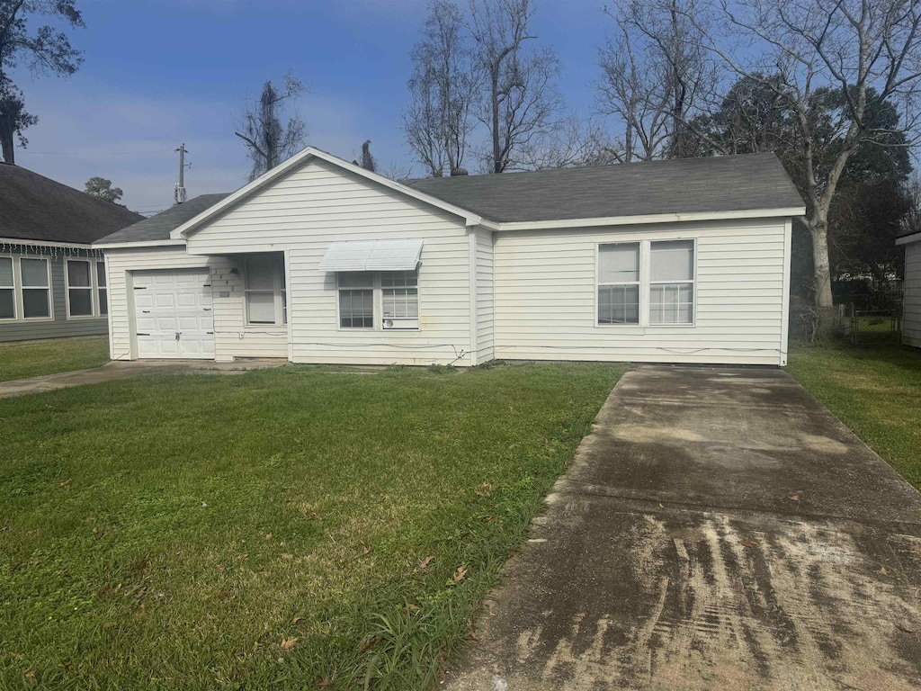 ranch-style home with a garage and a front yard