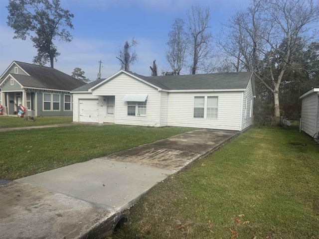 view of front of house with a front yard and a garage