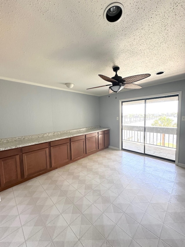 empty room featuring a textured ceiling and ceiling fan