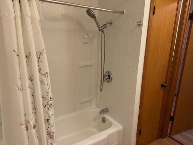 bathroom featuring shower / bathtub combination with curtain