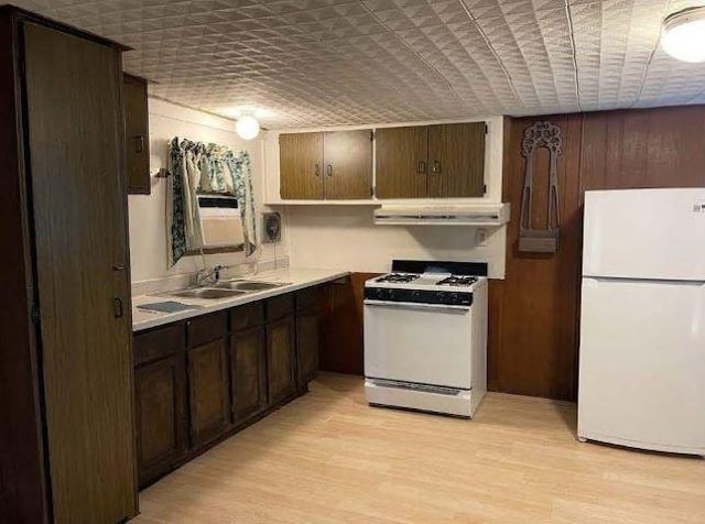 kitchen with sink, ventilation hood, white appliances, brick ceiling, and light wood-type flooring