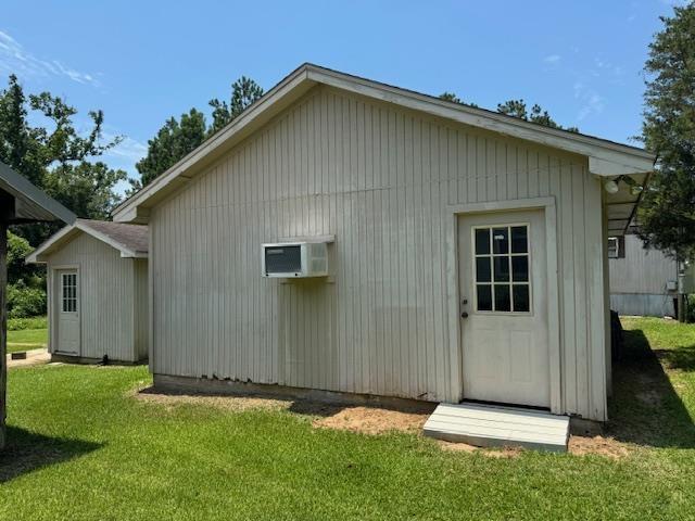 rear view of property featuring a yard