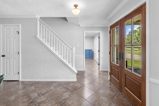 foyer entrance with ornamental molding and french doors