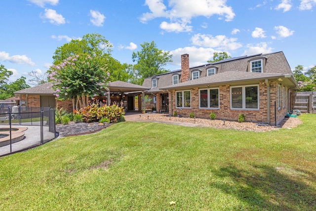 rear view of property with a yard