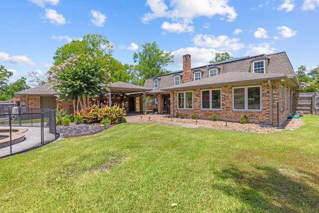 rear view of property with a yard