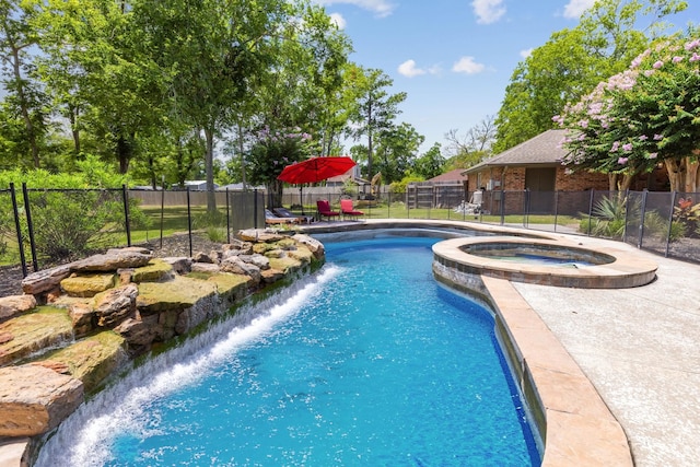 view of pool with an in ground hot tub and pool water feature