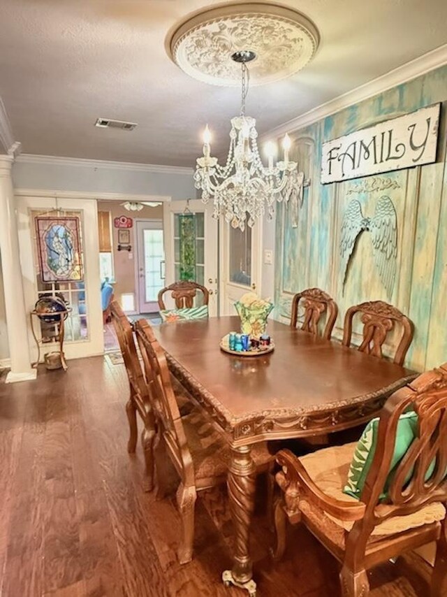 215 Wildwood Dr, Village Mills, TX 77663 - dining space featuring an inviting chandelier, ornamental molding, visible vents, wood finished floors, and baseboards