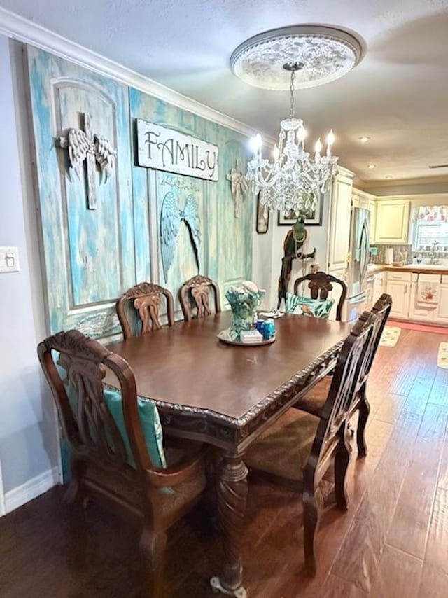 215 Wildwood Dr, Village Mills, TX 77663 - dining space with light wood finished floors, baseboards, an inviting chandelier, and ornamental molding