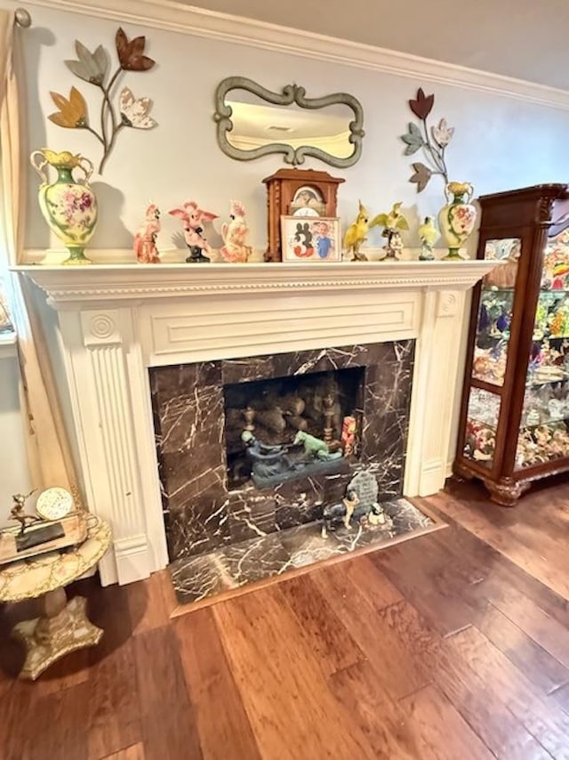 215 Wildwood Dr, Village Mills, TX 77663 - details with a high end fireplace, ornamental molding, and wood finished floors