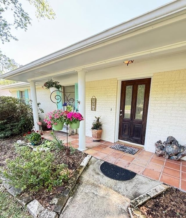 215 Wildwood Dr, Village Mills, TX 77663 - doorway to property with covered porch and brick siding