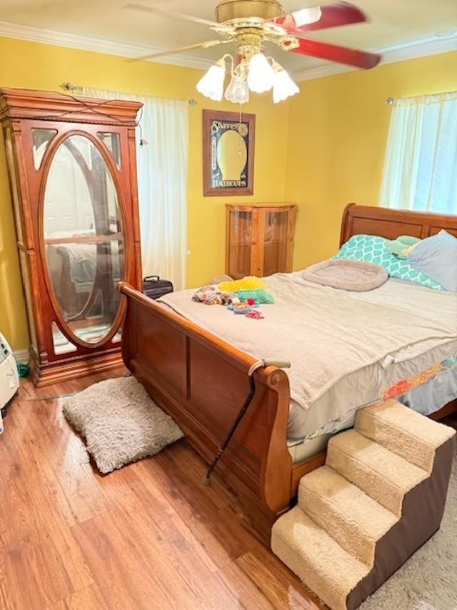 215 Wildwood Dr, Village Mills, TX 77663 - bedroom featuring ornamental molding, a ceiling fan, and wood finished floors