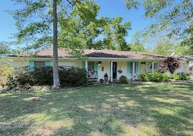 215 Wildwood Dr, Village Mills, TX 77663 - single story home with covered porch and a front lawn