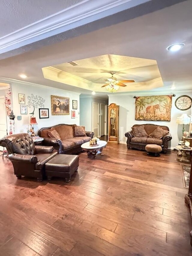 215 Wildwood Dr, Village Mills, TX 77663 - living area featuring a raised ceiling, crown molding, ceiling fan, and hardwood / wood-style flooring