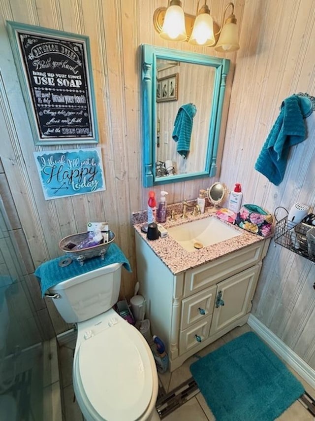 215 Wildwood Dr, Village Mills, TX 77663 - bathroom featuring wooden walls, toilet, and vanity