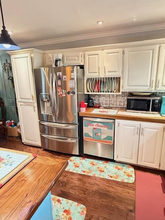 215 Wildwood Dr, Village Mills, TX 77663 - kitchen with white cabinets, appliances with stainless steel finishes, crown molding, wood finished floors, and butcher block countertops